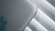 Load image into Gallery viewer, Detail of the Matrix MP-01 glass mouse pad edge backlit by window light