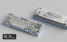 Load image into Gallery viewer, Render of Matrix Carnival keyboard in Anodized Light Blue, showing front with keycaps and back with decorative weight