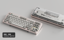 Load image into Gallery viewer, Render of Matrix Carnival keyboard in Anodized Light Pink, showing front with keycaps and back with decorative weight