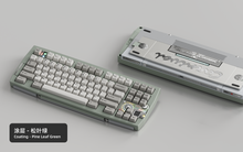 Load image into Gallery viewer, Render of Matrix Carnival keyboard in Coated Pine Leaf Green, showing front with keycaps and back with decorative weight