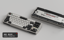 Load image into Gallery viewer, Render of Matrix Carnival keyboard in Coated Vintage Grey, showing front with keycaps and back with decorative weight