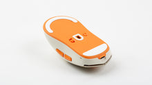 Load image into Gallery viewer, Underside of the beige NK-M1 mouse showing orange PTFE skates, optical sensor and USB-C port