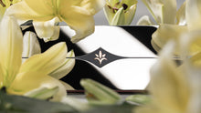 Load image into Gallery viewer, Close-up of a bow with a floral arrangement in the foreground