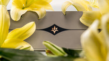 Load image into Gallery viewer, Product packaging with a floral design on a background of yellow flowers