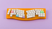 Load image into Gallery viewer, DSA Milkshake on an orange keyboard centered