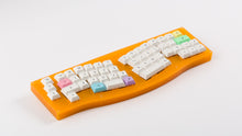 Load image into Gallery viewer, DSA Milkshake on an orange keyboard angled