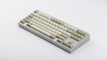 Load image into Gallery viewer, GMK CYL Hineybeige on a silver keyboard angled