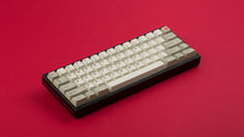Load image into Gallery viewer, GMK CYL Hineybeige on a black and red keyboard angled