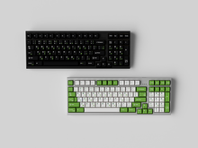 Load image into Gallery viewer, JTK Griseann on a black keyboard on top with JTK Royal Alpha on a gray keyboard below