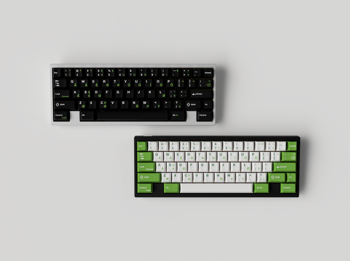  JTK Griseann on a white keyboard on top with JTK Royal Alpha on a black keyboard below 