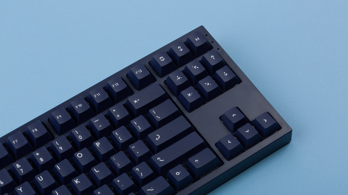  dark blue NK87 case with included dark milkshake themed keycaps  close up right side 