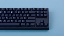 Load image into Gallery viewer, dark blue NK87 case with included dark milkshake themed keycaps  close up of right side monochrome