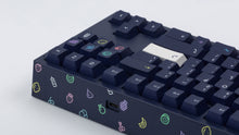 Load image into Gallery viewer, dark blue NK87 case with included dark milkshake themed keycaps  closeup of back view right side