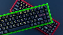 Load image into Gallery viewer, both pink and green cases featuring awaken keycaps stacked