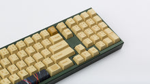 Load image into Gallery viewer, C-3PO keycaps on a dark green keyboard zoomed in to the right