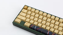 Load image into Gallery viewer, C-3PO keycaps on a dark green keyboard zoomed in to the left