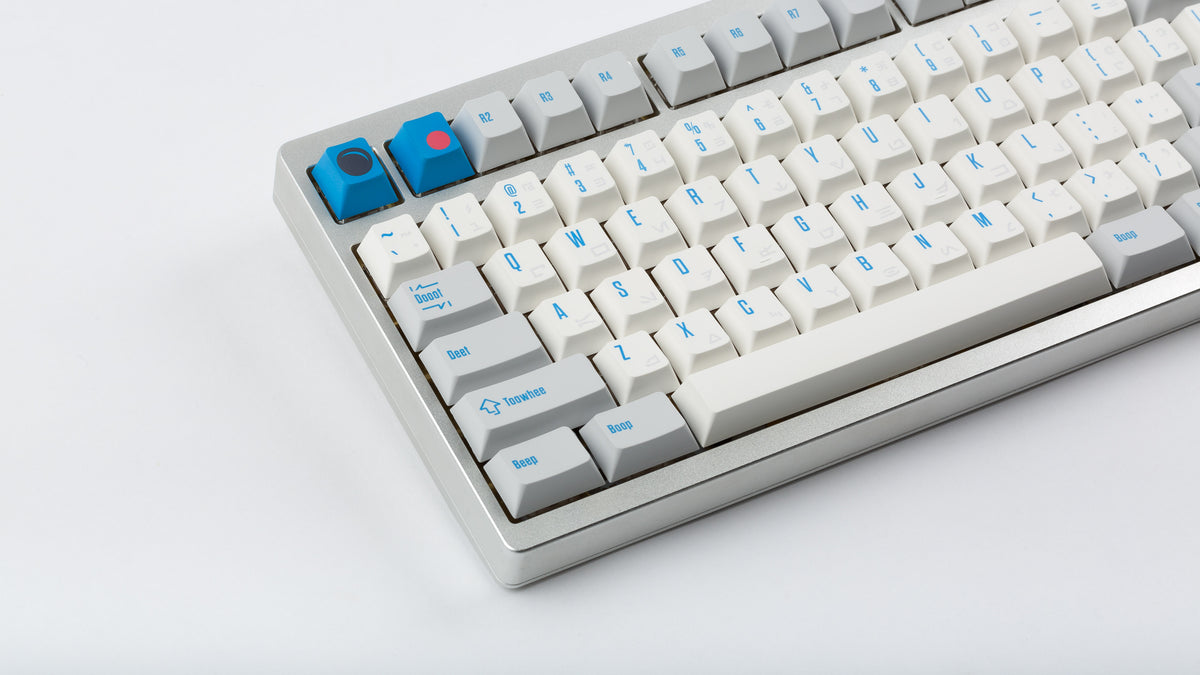  R2-D2 keycaps on a silver keyboard zoomed in on the left 