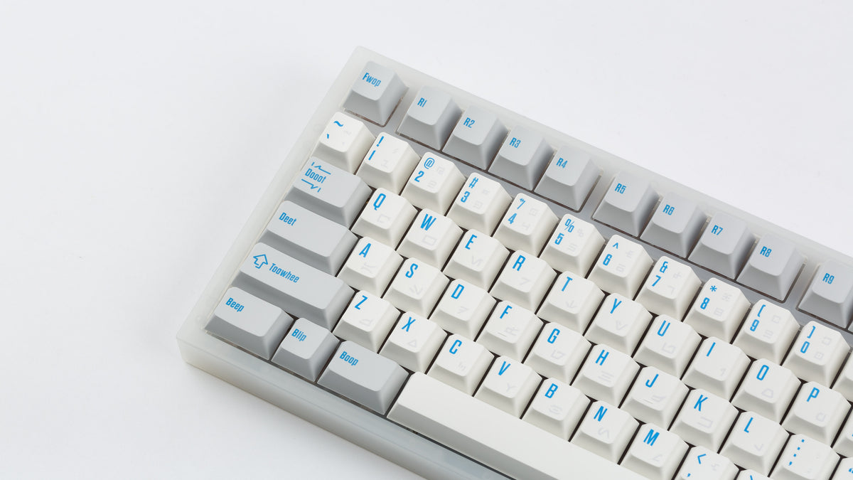  R2-D2 keycaps on a translucent NK87 zoomed in on the left 