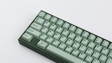 Load image into Gallery viewer, Cherry Sage on a dark green keyboard zoomed in on the left