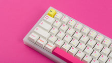 Load image into Gallery viewer, TFUE Keycaps on a translucent NK65 Keyboard zoomed in on left