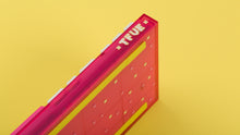 Load image into Gallery viewer, pink tfue themed keyboard with tfue keycaps on yellow background closeup of logo