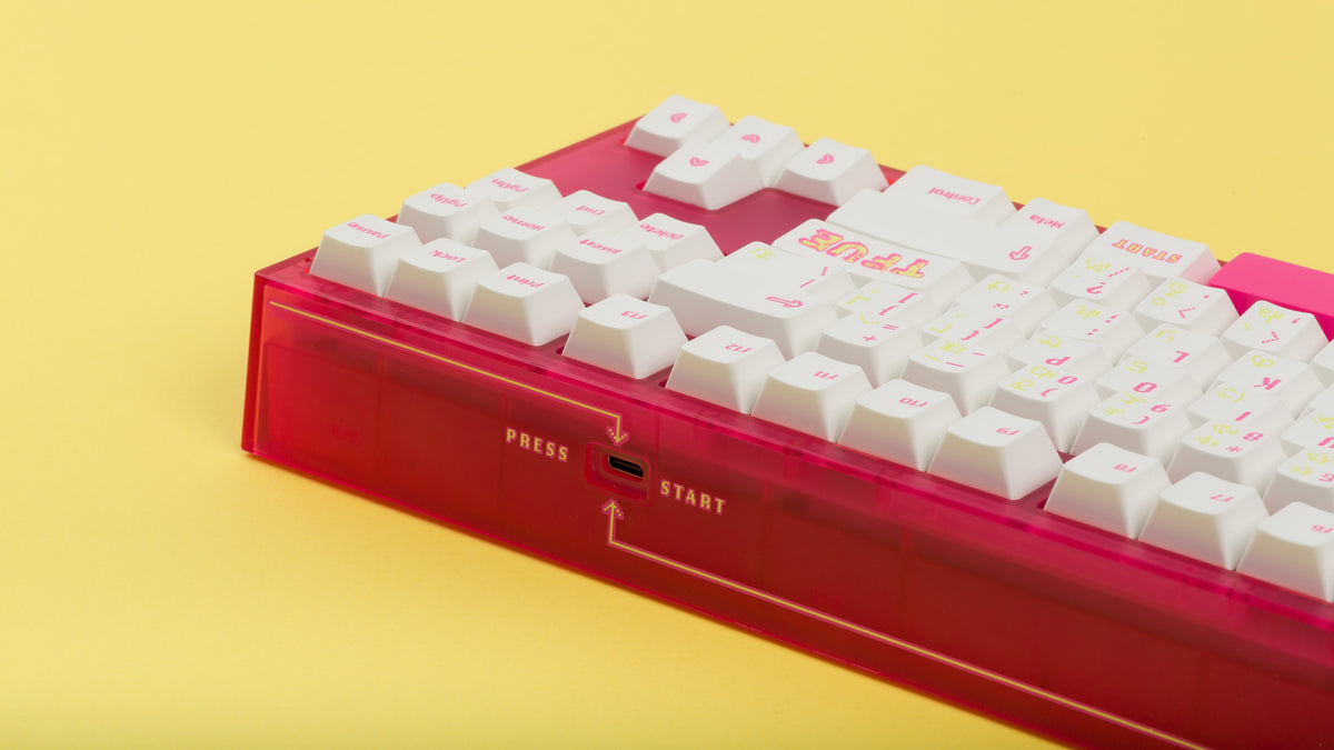  pink tfue themed keyboard with tfue keycaps usb type c close up on yellow background 